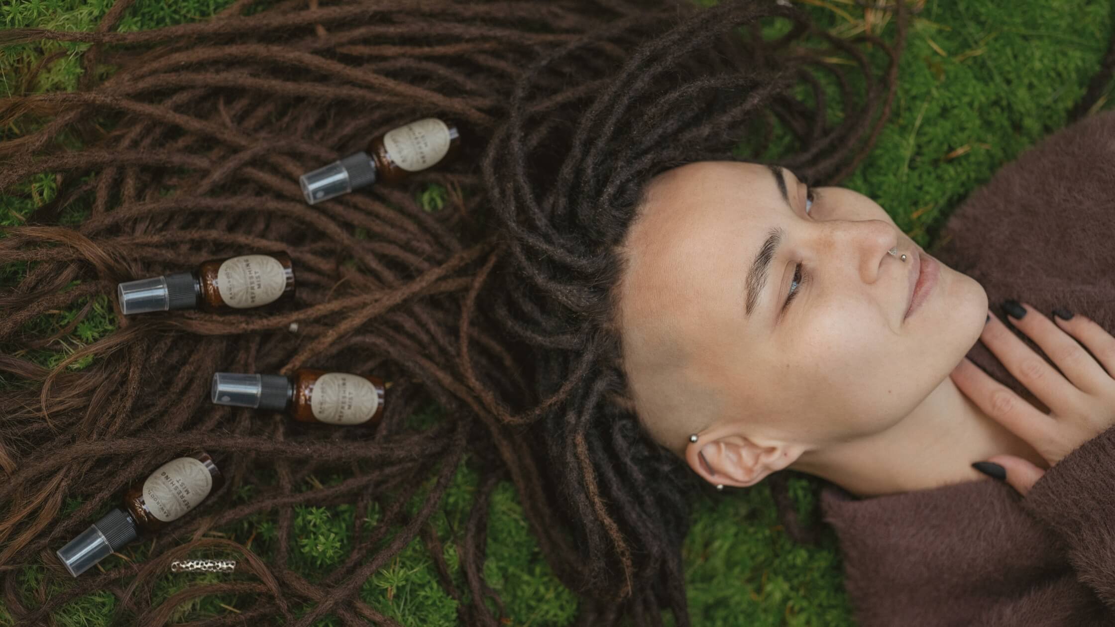 Natural dreadlock care routine with RAW ROOTs products placed in dreadlocks