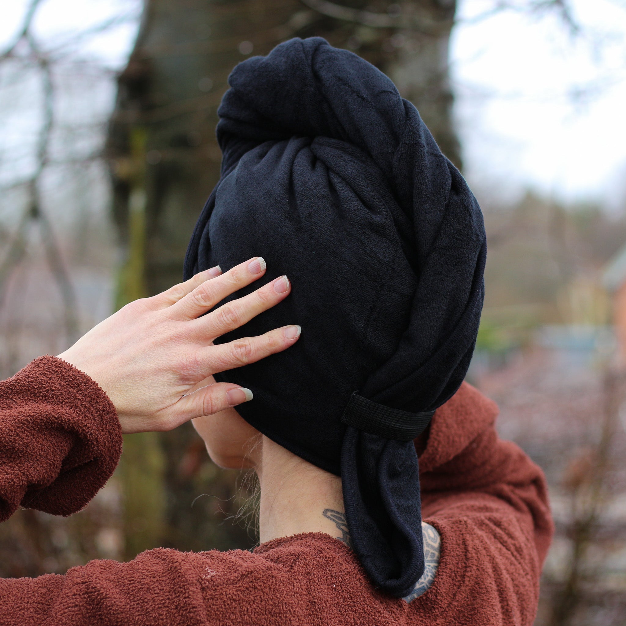 Person using a bamboo microfiber towel to dry dreadlocks after washing